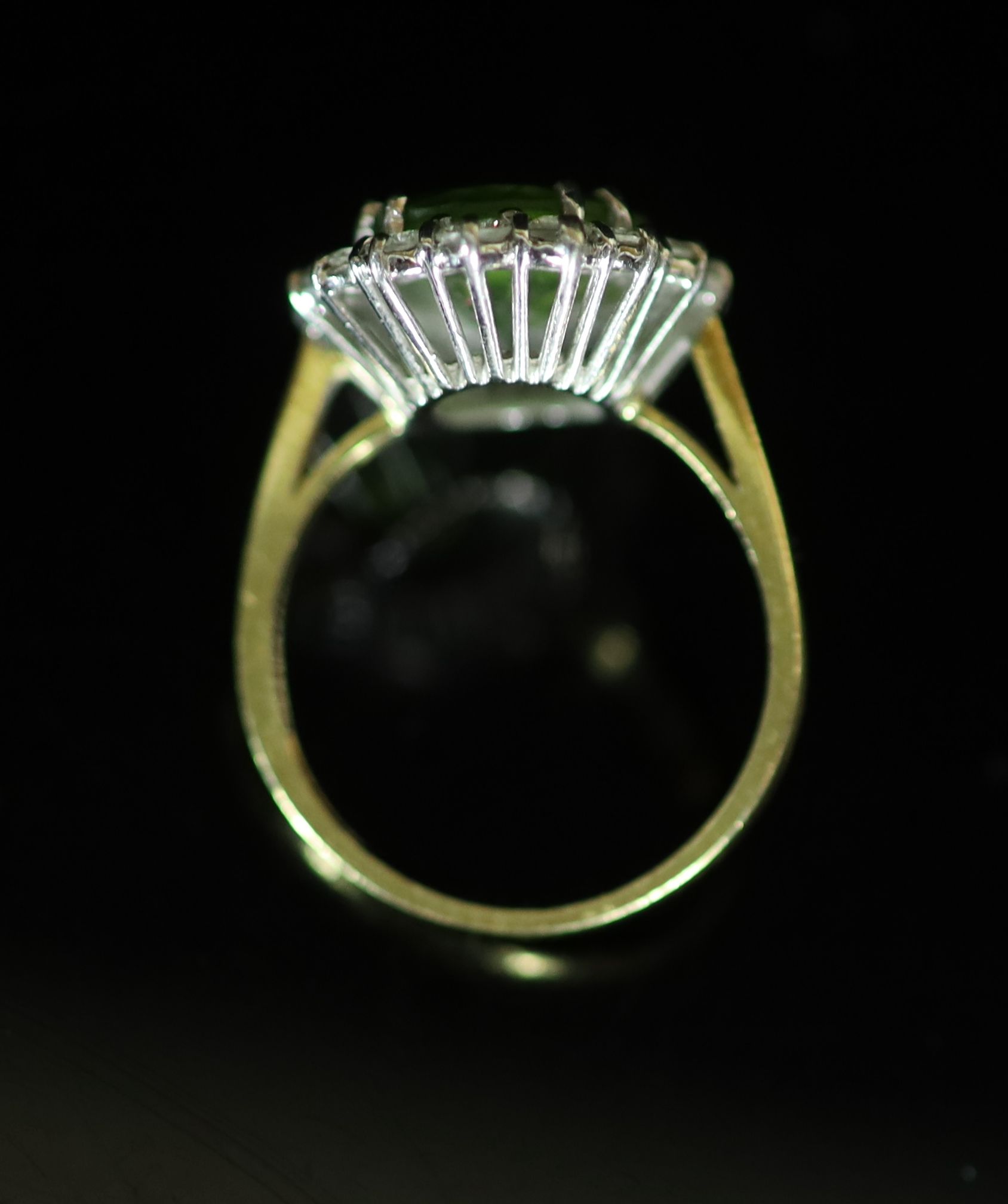 A modern 18ct gold, peridot and diamond set oval cluster ring